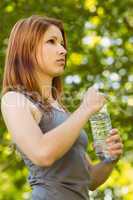 Pretty redhead holding a bottle of water