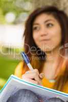 Female student doing homework in park