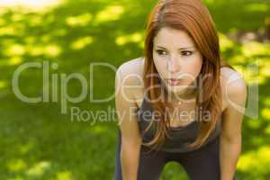 Pretty redhead panting in the park