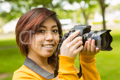 Beautiful female photographer at park