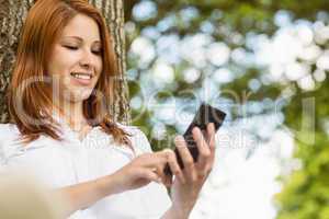 Pretty redhead text messaging on her phone