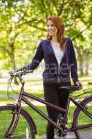 Pretty redhead with her bike
