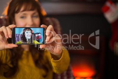 Pretty redhead taking a selfie at christmas