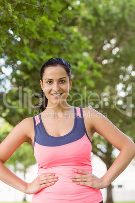 Smiling fit brunette looking at camera