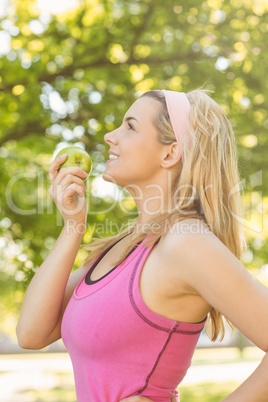 Fit blonde holding green apple