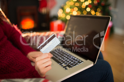 Woman shopping online with laptop at christmas