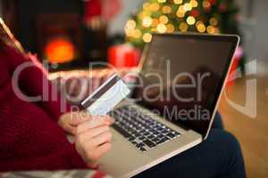 Woman shopping online with laptop at christmas