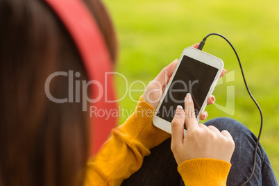 Close up of woman enjoying music in park