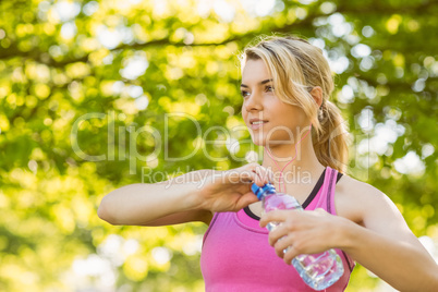 Fit blonde holding her water bottle