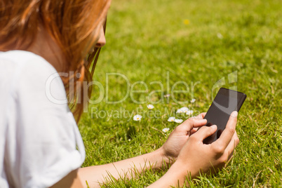 Pretty redhead text messaging on her phone