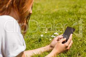 Pretty redhead text messaging on her phone