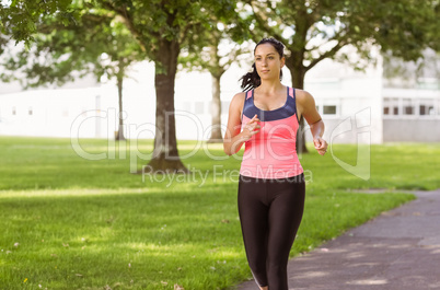 Fit brunette jogging in the park