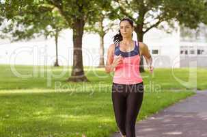 Fit brunette jogging in the park