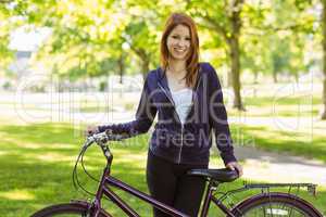 Pretty redhead with her bike