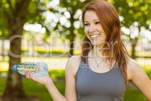 Pretty redhead holding a bottle of water