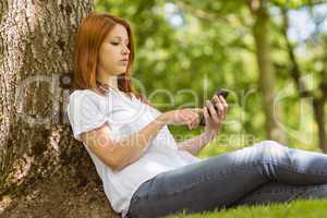 Pretty redhead text messaging on her phone