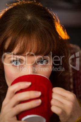 Portrait of redhead drinking hot drink at christmas Portrait of redhead drinking hot drink at christmas