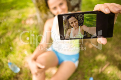 Smiling fit brunette taking a selfie
