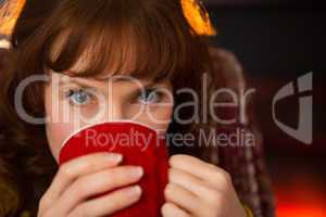 Portrait of beauty redhead drinking hot drink at christmas