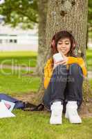 Beautiful woman enjoying music in park