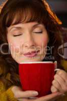 Portrait of redhead enjoying hot drink at christmas