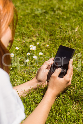 Pretty redhead text messaging on her phone