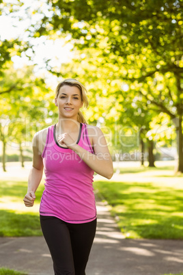 Fit blonde jogging in the park