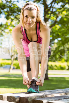 Fit blonde tying her shoelace