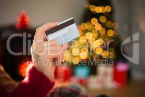 Woman showing credit card at christmas