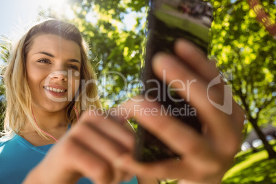 Fit blonde texting on her smartphone