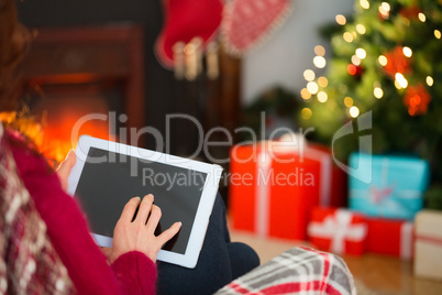 Redhead touching tablet at christmas