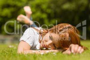 Pretty redhead napping on grass