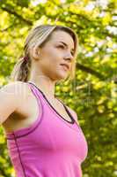 Fit blonde smiling in the park