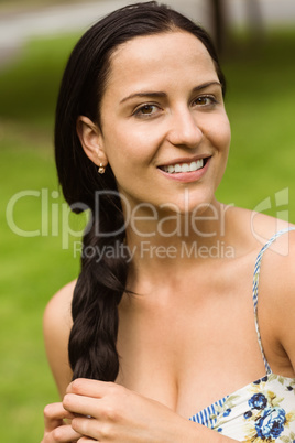Portrait of a pretty brunette holding her braid