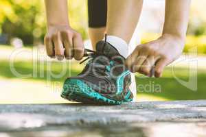 Fit woman tying her shoelace