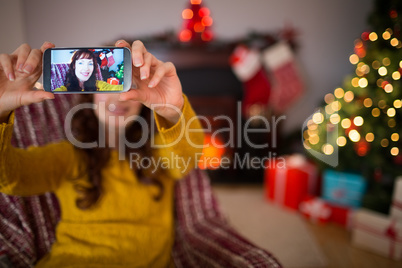 Beauty redhead taking a selfie at christmas