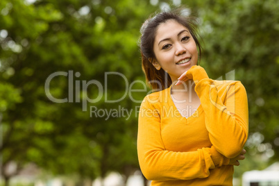 Beautiful woman with hand on chin in park