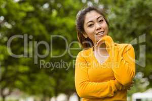 Beautiful woman with hand on chin in park