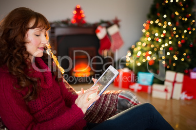 Redhead using digital tablet at christmas