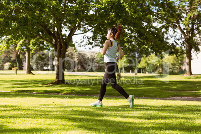 Healthy and beautiful woman jogging in park