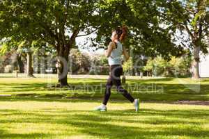 Healthy and beautiful woman jogging in park