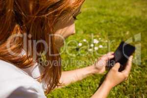 Pretty redhead text messaging on her phone