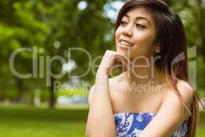 Beautiful woman with hand on chin in park