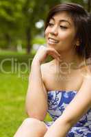 Beautiful woman with hand on chin in park