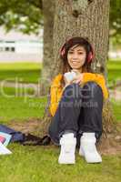 Relaxed woman enjoying music in park