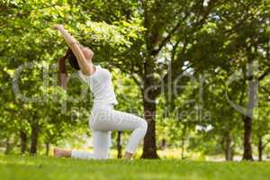 Healthy woman doing stretching exercises at park