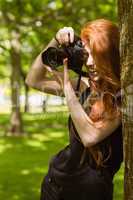 Beautiful female photographer at park