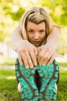 Fit blonde stretching on the grass