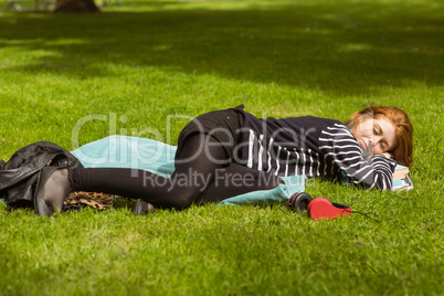 Full length of beautiful woman lying at park