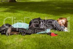 Full length of beautiful woman lying at park